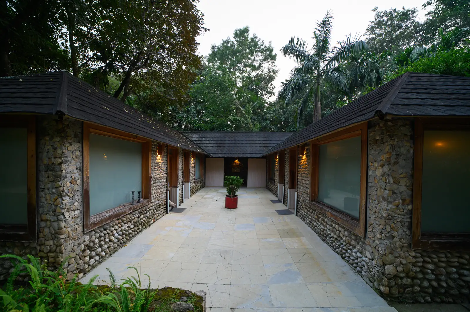 Cottage-style spa block set among trees at Sinclairs Darjeeling